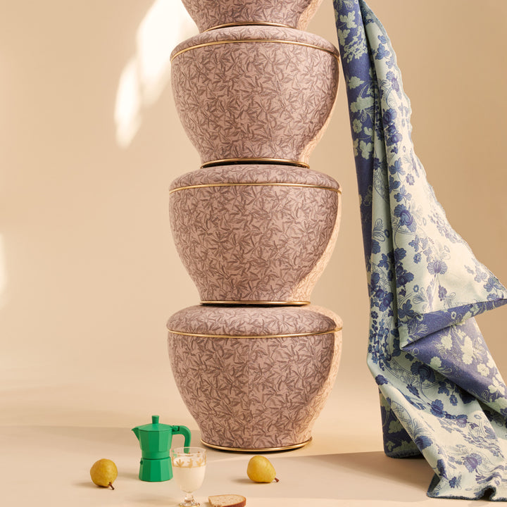 Stacked ceramic bowls, espresso maker, pears, and dessert on cloth