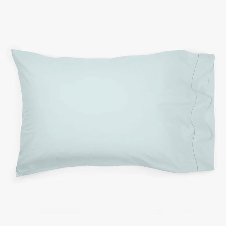 Light blue pillowcase on white background, softly creased, no patterns.