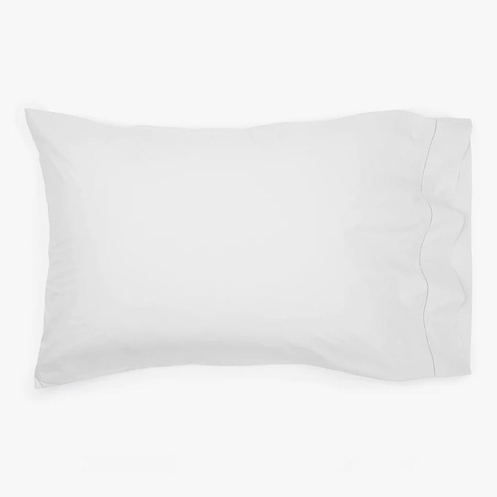 White rectangular bed pillow with smooth surface and faint padding outlines.