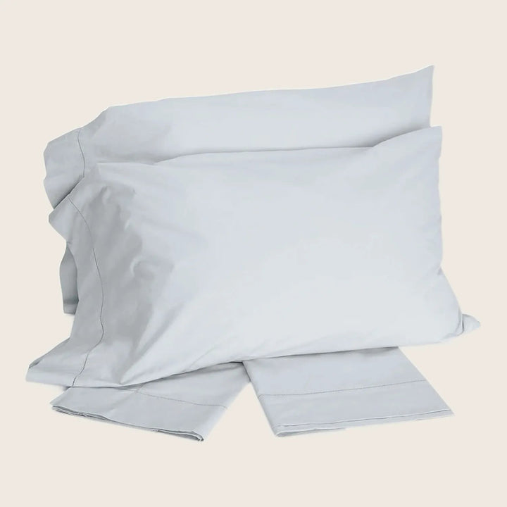 Set of luxurious pale silver bedding items neatly presented