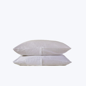 Two soft, stacked pink pillows on white background, comforting design. - hover