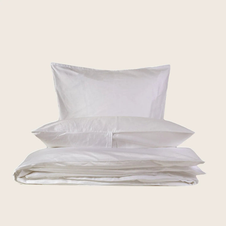 Crisp white bedding set with pillow and duvet on display.