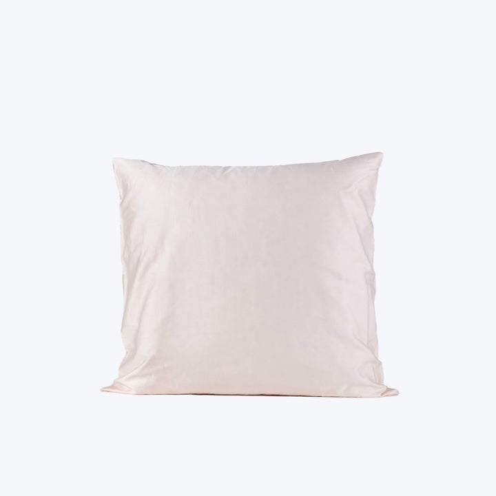 Minimalist square cotton pillow on white background, soft and plain.