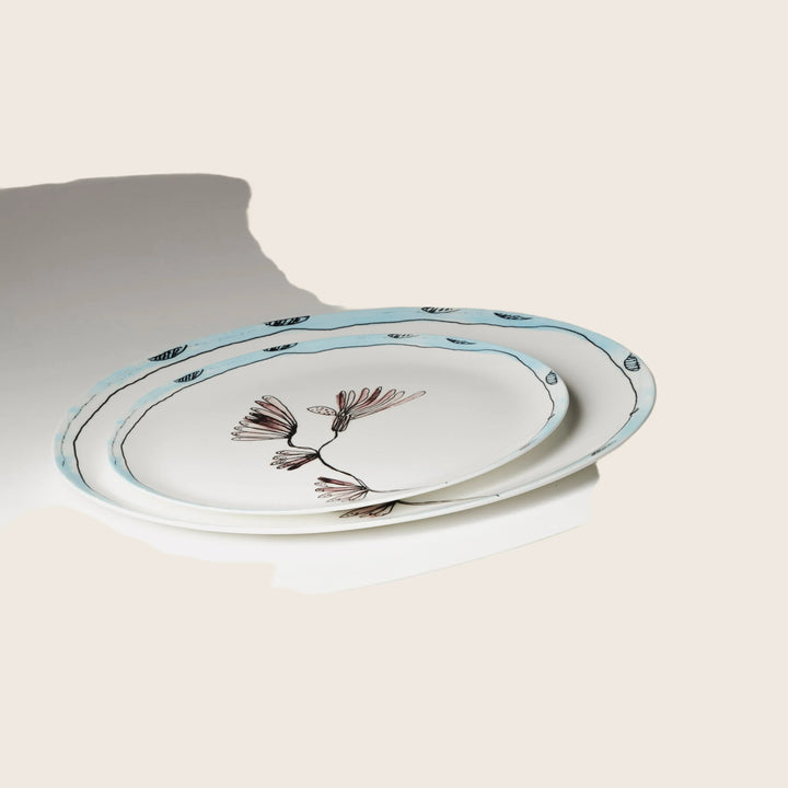 Two elegant plates with floral motifs on round table
