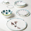 Artistic ceramic dishes with floral designs in pastel tones.