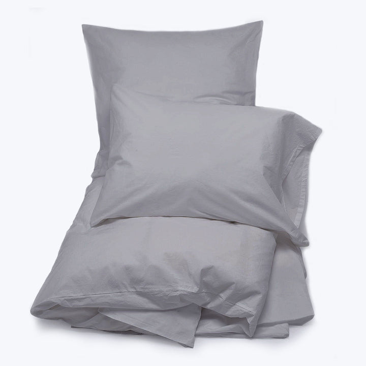 Light gray duvet cover and matching pillowcase laid flat