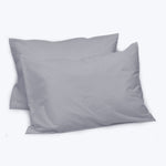 Two grey rectangular pillows with simple, clean design.