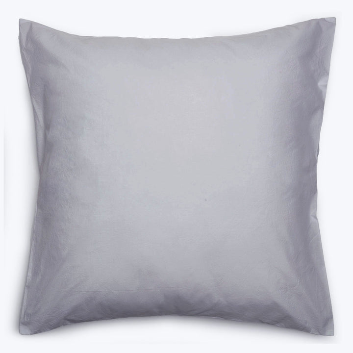 Single pillow without pillowcase on white background, square-shaped and smooth.