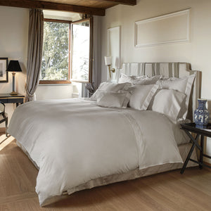 Neutral colored bedding set displayed in a stack, soft fabric - hover