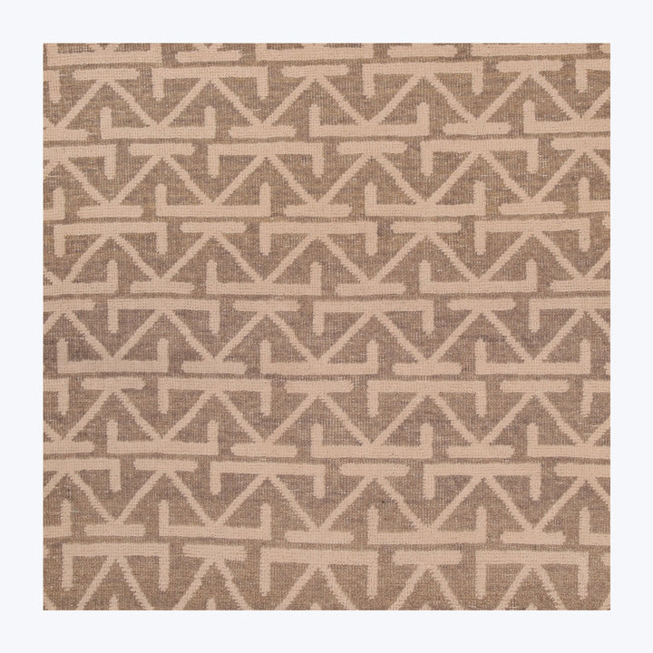 Modern geometric patterned textile in neutral colors for interior decor.