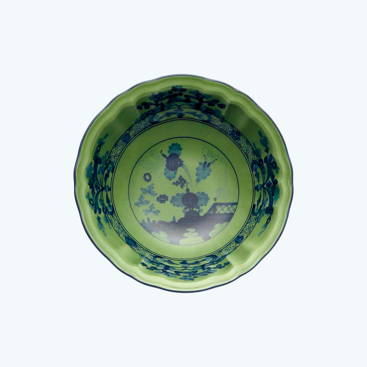 Traditional ceramic plate with vibrant green border and floral design.