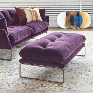 Plush purple ottoman with sleek metal frame exudes modern luxury. - hover