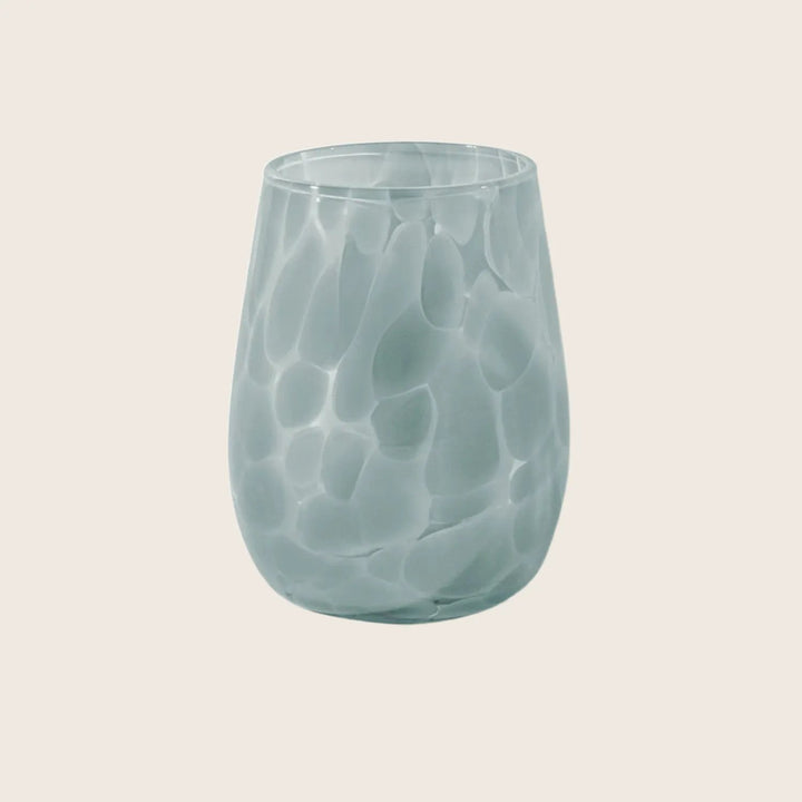 Textured glass with bulbous shape and pale blue color close-up.