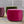 Three colorful cylindrical ottomans against industrial-style backdrop with area rug.