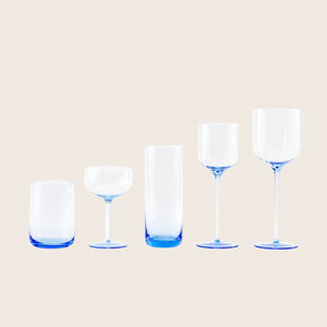 Empty blue tinted drinking glass on white background with shadow. - hover