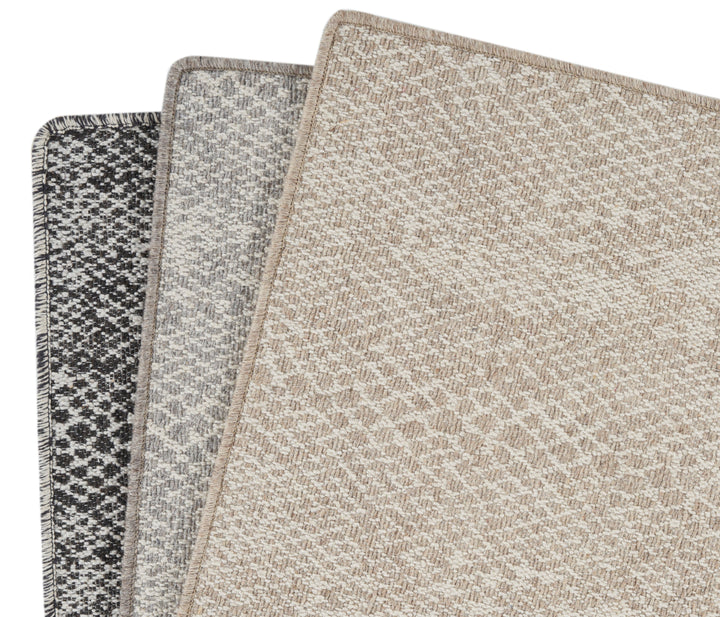Three carpet samples showcasing different colors and patterns for customers.