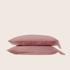 Two stacked gray pillows with pillowcases in light background setting. - hover