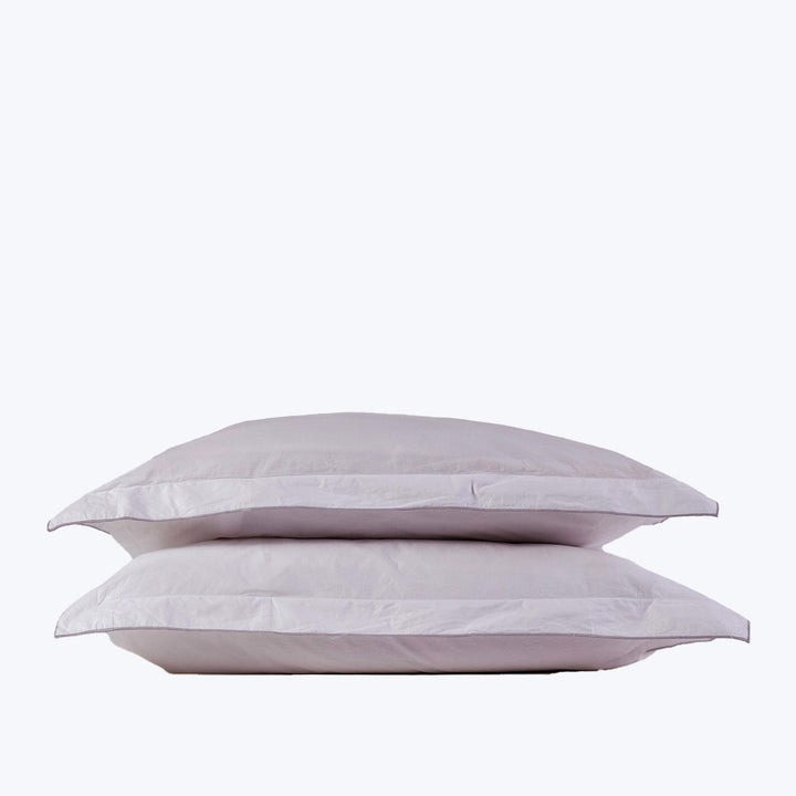 Two stacked white pillows on white background, fluffy and clean.