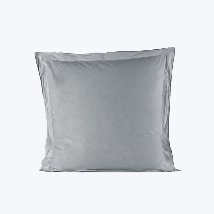 Fluffy gray pillow with smooth pillowcase on plain white background.