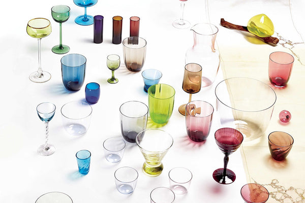 Diverse collection of glassware in vibrant colors showcased on display.