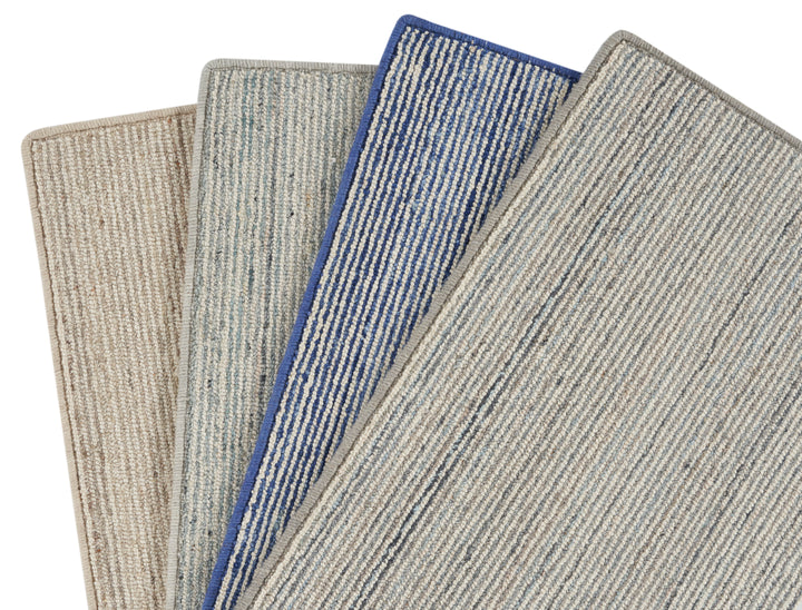 Three carpet samples with different textures and designs displayed neatly.