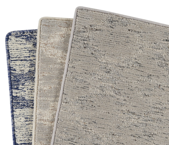 Carpet samples with various patterns and colors displayed closely together.