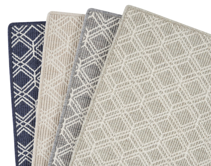 Four fabric swatches with different patterns and colors displayed together.