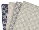 Four fabric swatches with different patterns and colors displayed together.