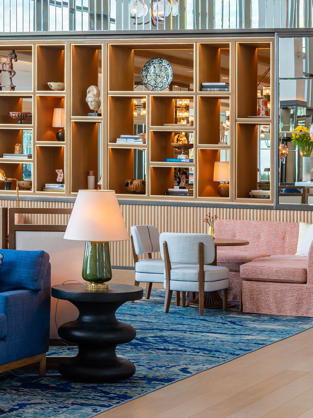 Elegantly furnished hotel lounge with stylish seating and artistic decor.