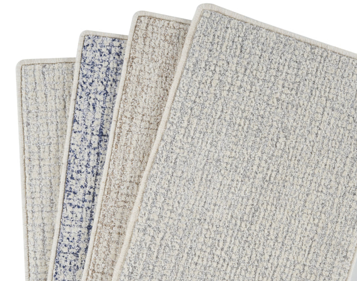Three carpet samples in beige, blue, and textured designs displayed.