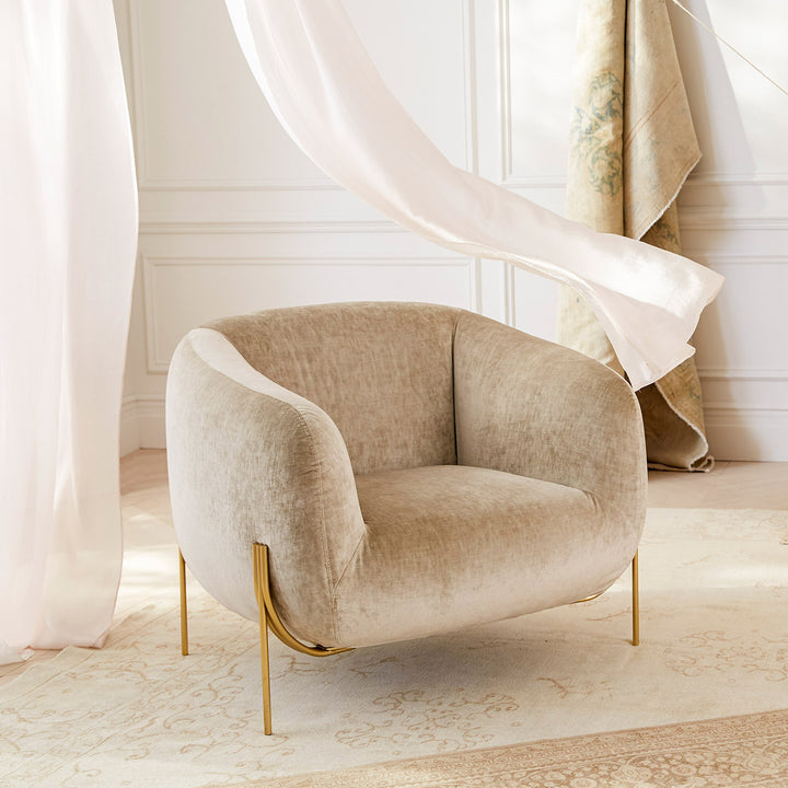 Elegant modern armchair with plush upholstery in classic architectural setting.