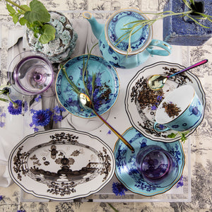 An oval decorative plate with detailed blue floral motifs - hover