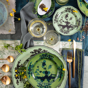 Traditional red floral ceramic plate with scalloped edge, top-down view. - hover