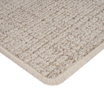 Close-up of beige heathered carpet with soft dense texture.