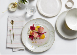 Handcrafted circular plate with textured glaze and distinct food placement area. - hover