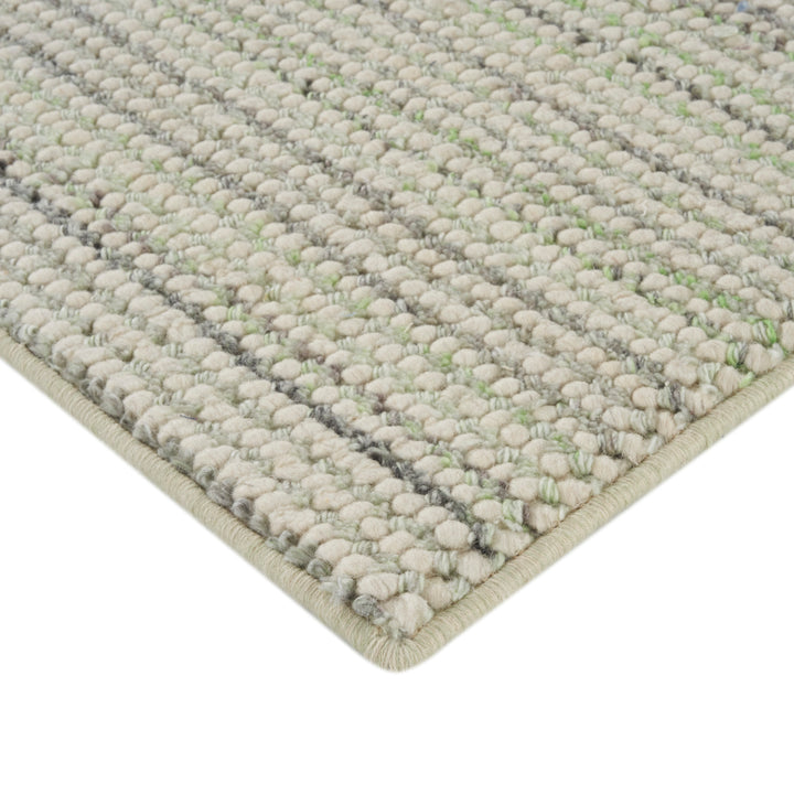 Close-up of loop pile carpet in neutral tones, soft texture.