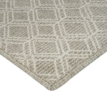 Close-up of high-quality beige textured rug with geometric pattern.