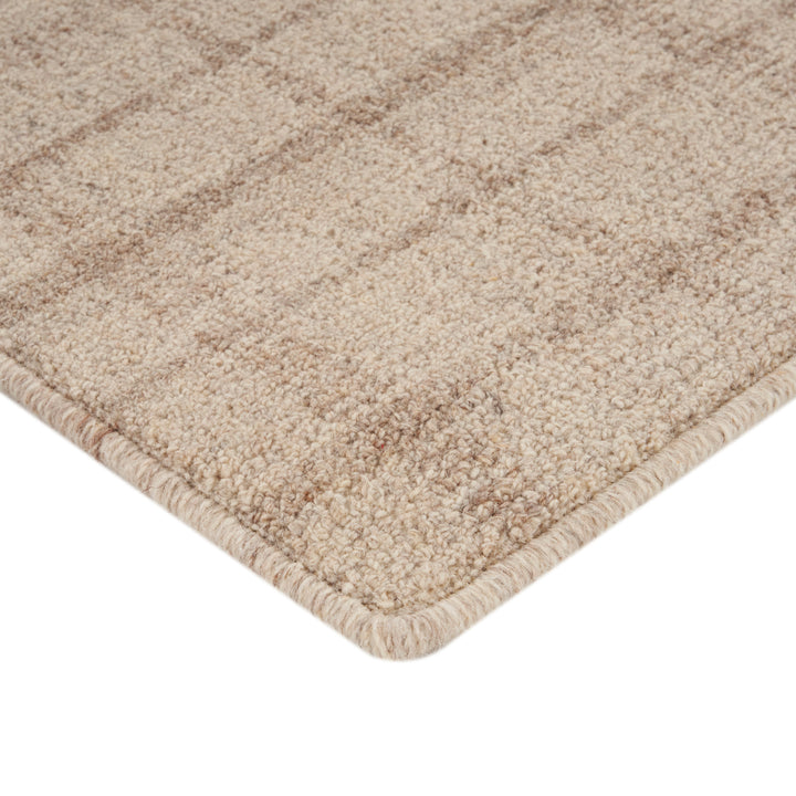 Soft plush carpet in neutral tones with bound finishing edge.