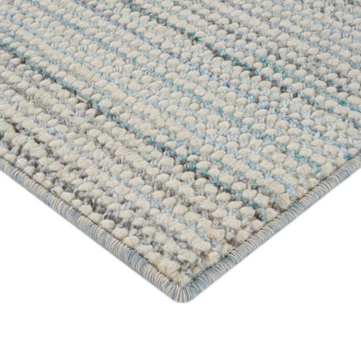 Close-up of soft, thick tufted textile in shades of grey.