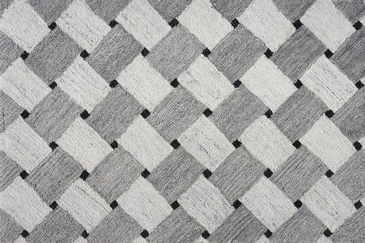 Close-up of textured fabric with geometric pattern in neutral colors.