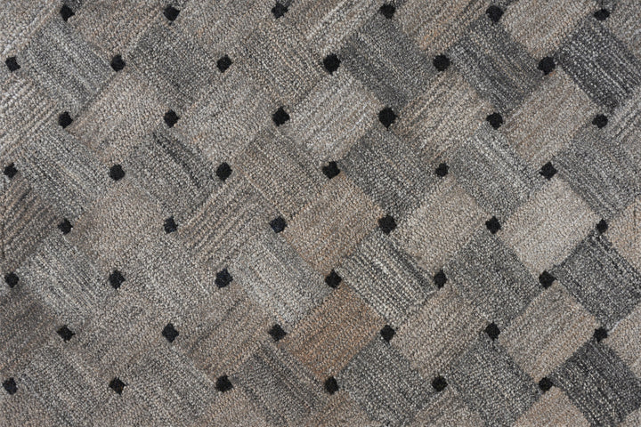 Close-up of textured fabric with diamond pattern in neutral tones.