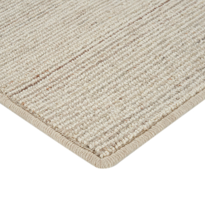 Close-up of durable, neutral-colored rug with tight weave texture.