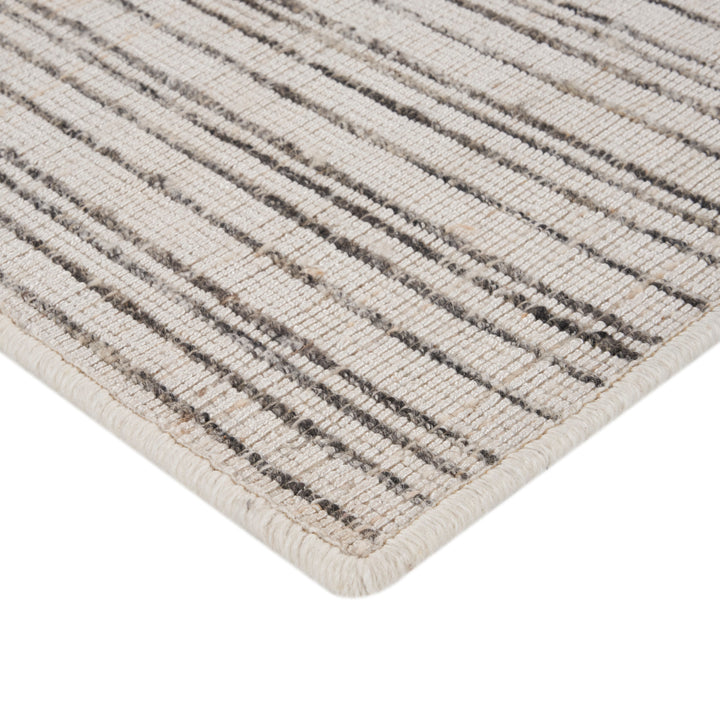 Modern striped rug in neutral tones with loop pile texture.