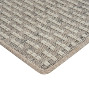Close-up of durable rug with alternating colors, raised tufts. - hover