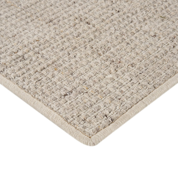 Close-up of textured loop pile rug with heathered look.