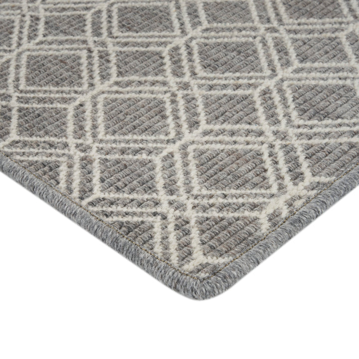 Close-up of modern geometric rug in shades of grey.