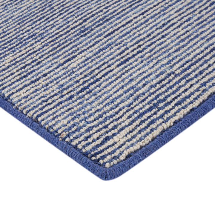 Close-up of durable blue and off-white striped woven rug texture.