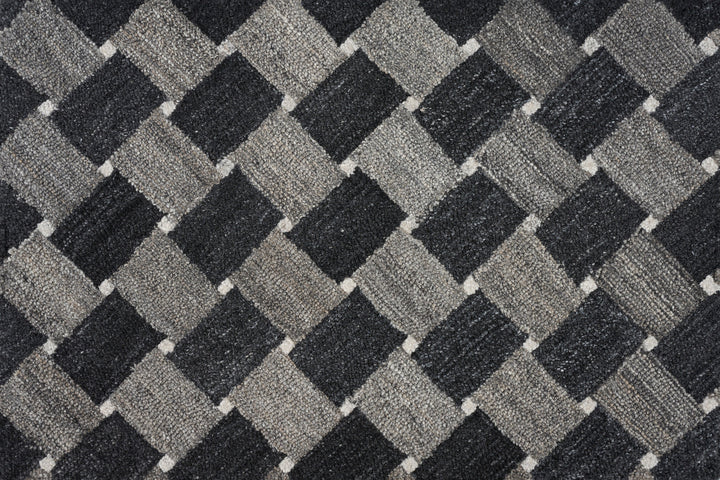 Close-up of textured fabric with diagonal checkered pattern in grayscale.
