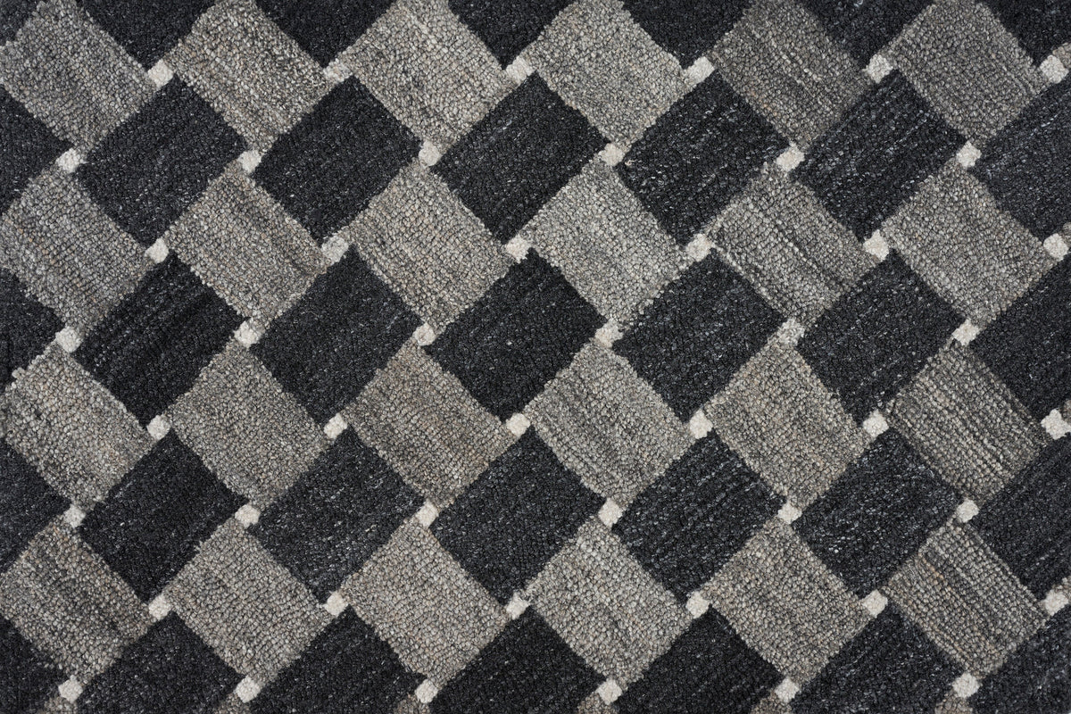 Close-up of textured fabric with diagonal checkered pattern in grayscale.