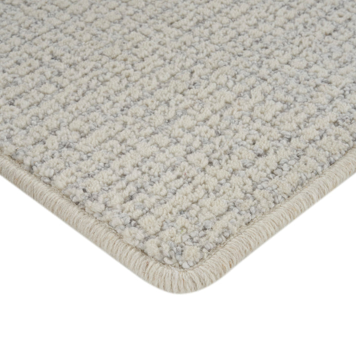 Textured beige and grey carpet with checkered pattern and border.